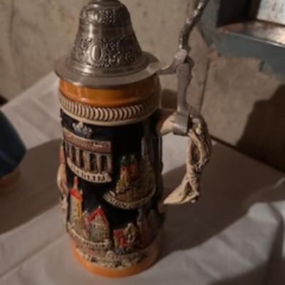 BEER STEINS, SWISS GIRL FIGURINE AND A CARVED CANDLE