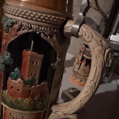 BEER STEINS, SWISS GIRL FIGURINE AND A CARVED CANDLE
