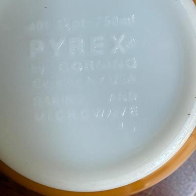 Sale Photo Thumbnail #170: This is for three Pyrex bowls. Two are orange and one is a cream, yellow type color with fruit marked on it.
