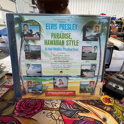 Sale Photo Thumbnail #201: Paradise, Hawaiian Style by Elvis Presley. 
Here are some details about the album:
Release Information: It is the thirteenth soundtrack album by Elvis Presley, released by RCA Victor in June 1966, available in both mono (LPM) and stereo (LSP) formats with