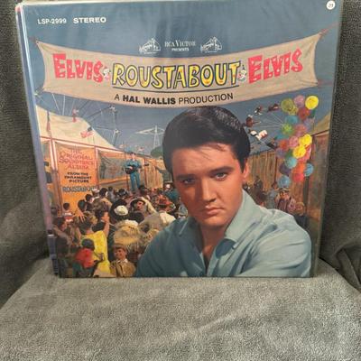 Sale Photo Thumbnail #6: "Roustabout," the soundtrack to the 1964 American musical film of the same name starring Elvis Presley. 
Here are some details about the album and film:
Release Information: "Roustabout" is the ninth soundtrack album by Elvis Presley, released in October 