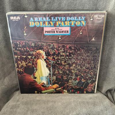 Sale Photo Thumbnail #244: "A Real Live Dolly" by Dolly Parton. 
Here's more information about the album:
Release and Recording: Released on June 29, 1970, by RCA Victor, "A Real Live Dolly" is Dolly Parton's first live album. It was recorded on April 15, 1970, at her high school i