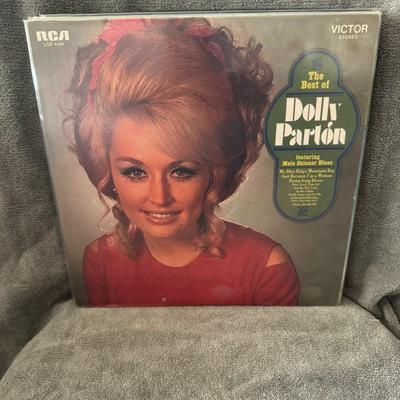 Sale Photo Thumbnail #242: "The Best of Dolly Parton", a compilation album by American singer-songwriter Dolly Parton. 
Key details about the album:
Release Date: November 9, 1970, released by RCA Victor.
Catalog Number: LSP-4445, as seen on the album cover [OCR text].
Content: The