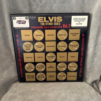 Sale Photo Thumbnail #205: "Elvis The Other Sides – Elvis Worldwide Gold Award Hits Vol. 2", a compilation album by Elvis Presley. 
Here are some key details about this album:
Release Date: It was released on August 1, 1971.
Format: This is a 4xLP (four-record) vinyl box set, typ