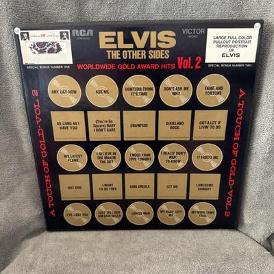 Sale Photo Thumbnail #204: "Elvis The Other Sides – Elvis Worldwide Gold Award Hits Vol. 2", a compilation album by Elvis Presley. 
Here are some key details about this album:
Release Date: It was released on August 1, 1971.
Format: This is a 4xLP (four-record) vinyl box set, typ