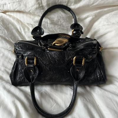Sale Photo Thumbnail #1: • iconic 2000s / 2010s chloe paddington shoulder bag ???
• in lovely condition
• signs of wear on the hardware
• functional padlock
• can fit so much inside
• bag is literally to die for & the pics do not do it justice
• patent black
• sou