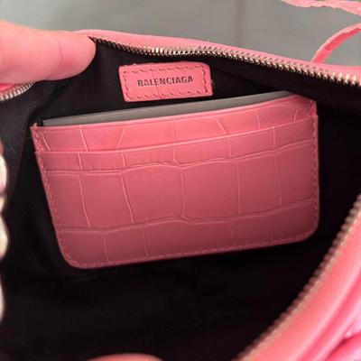 Sale Photo Thumbnail #19: Pink Croc Embossed Le Cagole Mini Bag with chain shoulder strap with a hook
Adjustable and removable shoulder strap
Antique silver finishes
Zipper closure with knotted leather pulls
Two internal compartments for credit cards
Cotton canvas lining
100% Leat
