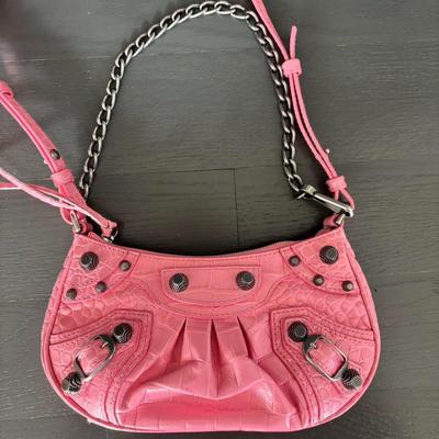 Sale Photo Thumbnail #21: Pink Croc Embossed Le Cagole Mini Bag with chain shoulder strap with a hook
Adjustable and removable shoulder strap
Antique silver finishes
Zipper closure with knotted leather pulls
Two internal compartments for credit cards
Cotton canvas lining
100% Leat