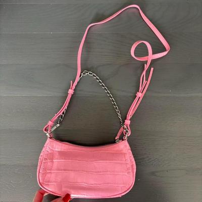 Sale Photo Thumbnail #20: Pink Croc Embossed Le Cagole Mini Bag with chain shoulder strap with a hook
Adjustable and removable shoulder strap
Antique silver finishes
Zipper closure with knotted leather pulls
Two internal compartments for credit cards
Cotton canvas lining
100% Leat