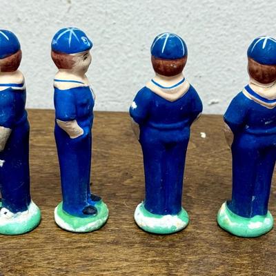 Sale Photo Thumbnail #34: Set of 4 Cub Scout figurines.  The one on the right end has been repaired, the head was glued back on (not very noticeable). Approx. 3” tall.