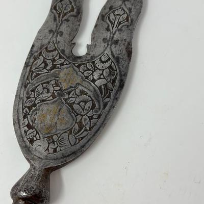 Sale Photo Thumbnail #28: 13” blade 9” shaft
Persian wavy two-pronged spearheads have been in use since the 16th Century. The majority of examples available today date back to the Qajar period. The base of the blade is decorated with chiseled ornate motifs along with small inl