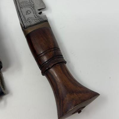 Sale Photo Thumbnail #51: Rare piece in excellent condition.  7” blade and hand carved wood handle
The Gurkha Kukri was commonly used as a weapon or in ceremonies. The blade features a cut-out right below the grip. It is said that it resembles Shiva, a cow's foot as a reminder n
