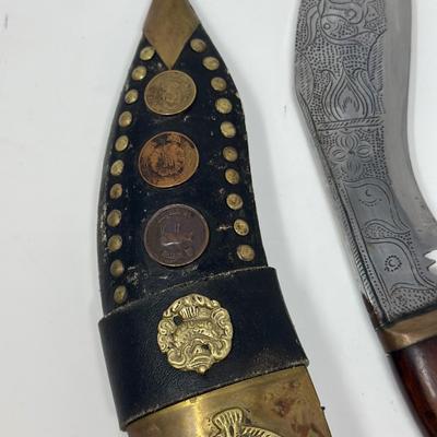 Sale Photo Thumbnail #49: Rare piece in excellent condition.  7” blade and hand carved wood handle
The Gurkha Kukri was commonly used as a weapon or in ceremonies. The blade features a cut-out right below the grip. It is said that it resembles Shiva, a cow's foot as a reminder n