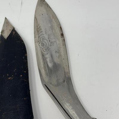 Sale Photo Thumbnail #57: Made in India. The blade is carbon steel and measures 11.06” long by 14.62” overall
The Gurkha Kukri was commonly used as a weapon or in ceremonies. The blade features a cut-out right below the grip. It is said that it resembles Shiva, a cow's foot as