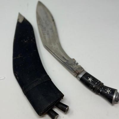 Sale Photo Thumbnail #55: Made in India. The blade is carbon steel and measures 11.06” long by 14.62” overall
The Gurkha Kukri was commonly used as a weapon or in ceremonies. The blade features a cut-out right below the grip. It is said that it resembles Shiva, a cow's foot as