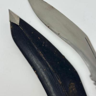 Sale Photo Thumbnail #61: Made in India. The blade is carbon steel and measures 11.06” long by 14.62” overall
The Gurkha Kukri was commonly used as a weapon or in ceremonies. The blade features a cut-out right below the grip. It is said that it resembles Shiva, a cow's foot as