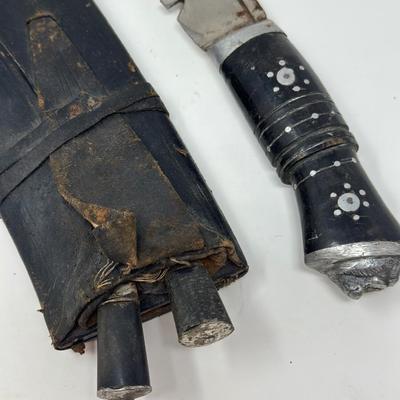 Sale Photo Thumbnail #59: Made in India. The blade is carbon steel and measures 11.06” long by 14.62” overall
The Gurkha Kukri was commonly used as a weapon or in ceremonies. The blade features a cut-out right below the grip. It is said that it resembles Shiva, a cow's foot as