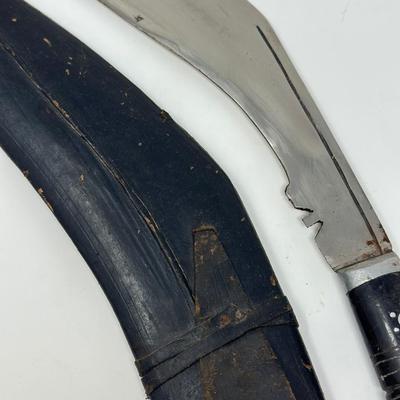 Sale Photo Thumbnail #60: Made in India. The blade is carbon steel and measures 11.06” long by 14.62” overall
The Gurkha Kukri was commonly used as a weapon or in ceremonies. The blade features a cut-out right below the grip. It is said that it resembles Shiva, a cow's foot as