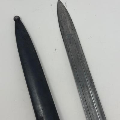 Sale Photo Thumbnail #79: Blade is 11 3/4” long and 17 1/2” long overall 
Waffenfabrik Neuhausen Bayonet. Stamped 460779. Inlaid metal swastika in wooden and metal hilt.