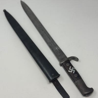 Sale Photo Thumbnail #75: Blade is 11 3/4” long and 17 1/2” long overall 
Waffenfabrik Neuhausen Bayonet. Stamped 460779. Inlaid metal swastika in wooden and metal hilt.