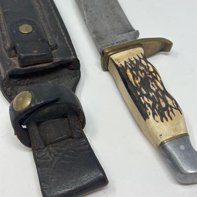 Sale Photo Thumbnail #96: Pro hunter fixed blade knife with birds head pommel and brass finger guard, c. 1971-72. Leather sheath 10 1/2” overall length