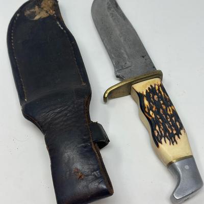 Sale Photo Thumbnail #99: Pro hunter fixed blade knife with birds head pommel and brass finger guard, c. 1971-72. Leather sheath 10 1/2” overall length