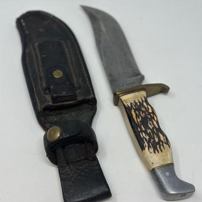 Sale Photo Thumbnail #95: Pro hunter fixed blade knife with birds head pommel and brass finger guard, c. 1971-72. Leather sheath 10 1/2” overall length