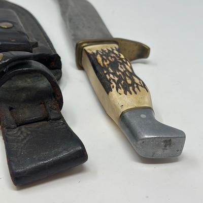 Sale Photo Thumbnail #100: Pro hunter fixed blade knife with birds head pommel and brass finger guard, c. 1971-72. Leather sheath 10 1/2” overall length