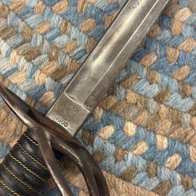 Sale Photo Thumbnail #112: Manufactured by the Ames sword company, the model 1906. Xavior was an updated model 1860 like Calvary Saber. The Saber has a 34 7/8 inch bright double fuller blade, with USJC restamped on the left ricasso and A.S. Co. above ordinance , shell and flame ins