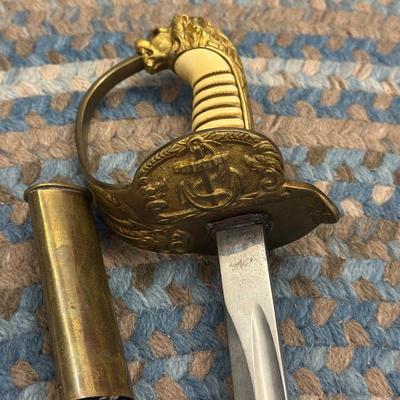 Sale Photo Thumbnail #120: This is an original World War II Kriegsmarine  (Nazi Navy) sword.  These weren’t used in combat but rather for parades and a symbol of status. The sword is maker stamped by E. F. Horster. The scabbard is damaged as shown in photos.