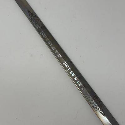 Sale Photo Thumbnail #125: C. 1800s, the blade near the hilt is etched The M.C. Likely & Co.  Columbus, O.  It is etched in the middle of the blade depicting 'LOOM' with a moose head. The skin grip is in nice condition. The blade measures 28 inches in length.