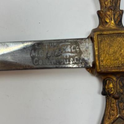 Sale Photo Thumbnail #128: C. 1800s, the blade near the hilt is etched The M.C. Likely & Co.  Columbus, O.  It is etched in the middle of the blade depicting 'LOOM' with a moose head. The skin grip is in nice condition. The blade measures 28 inches in length.