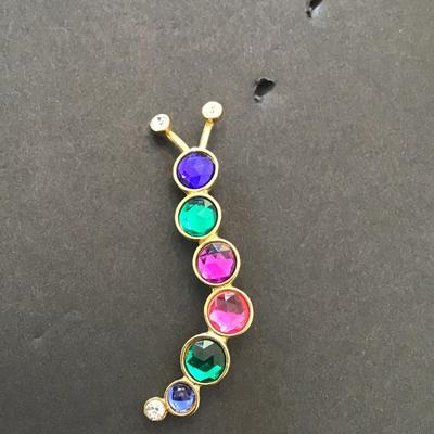 Sale Photo Thumbnail #118: Vintage gold tone, multi colored Caterpillar type brooch. Please see attached photos.