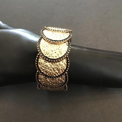 Sale Photo Thumbnail #155: Very nice hammered gold tone, stretchy bracelet. Please see attached photos.