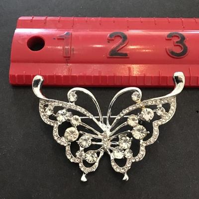 Silver toned butterfly brooch with rhinestones