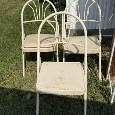Three metal folding chairs and shelf for over the toilet
