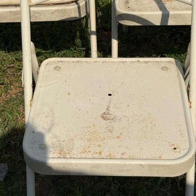 Three metal folding chairs and shelf for over the toilet