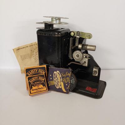 LOT 92L: Lindstrom 16mm Projector with Mutt & Jeff, Charlie Chaplin, Ken Maynard Reels