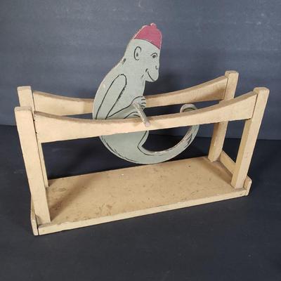 LOT 99L: Disney Fisher Price Pluto Pop Up, Monkey Jester Flip Toy, and Hand Carved Movable Wooden Toys