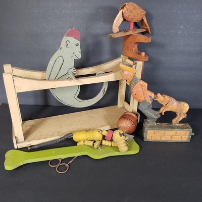 LOT 99L: Disney Fisher Price Pluto Pop Up, Monkey Jester Flip Toy, and Hand Carved Movable Wooden Toys