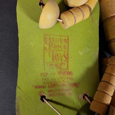 LOT 99L: Disney Fisher Price Pluto Pop Up, Monkey Jester Flip Toy, and Hand Carved Movable Wooden Toys