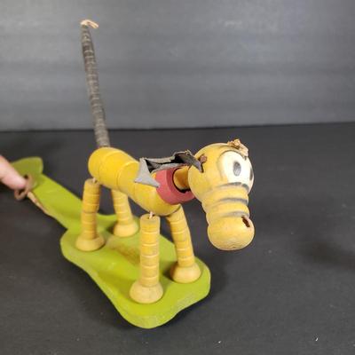 LOT 99L: Disney Fisher Price Pluto Pop Up, Monkey Jester Flip Toy, and Hand Carved Movable Wooden Toys
