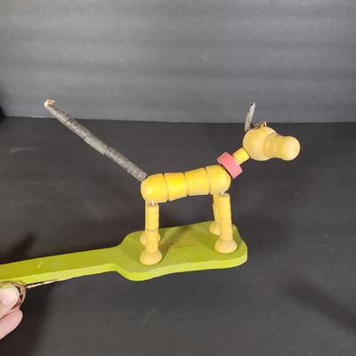 LOT 99L: Disney Fisher Price Pluto Pop Up, Monkey Jester Flip Toy, and Hand Carved Movable Wooden Toys