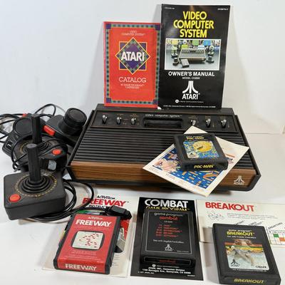 LOT 137L: Vintage 1980s Atari Video Computer System Model CX-2600 w/ Manual, 2 Joysticks, 2 Paddles, Power Cord & 4 Games w/...