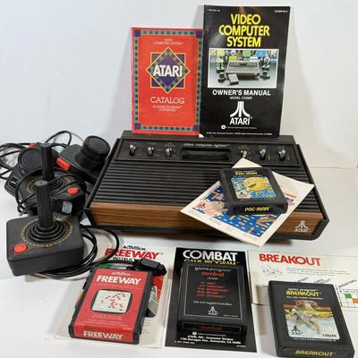 LOT 137L: Vintage 1980s Atari Video Computer System Model CX-2600 w/ Manual, 2 Joysticks, 2 Paddles, Power Cord & 4 Games w/...