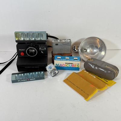 LOT 221L: Vintage Polaroid Pronto Land Camera w/ Flash Bars & More