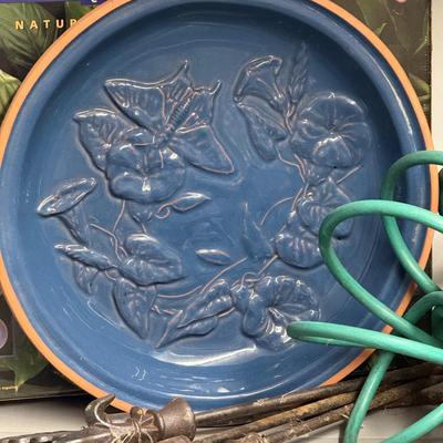 Sale Photo Thumbnail #1196: One Spiral Garden Hose, royal blue glazed bird bath, Chemical hose nossle, brush nossle, four wrought iron lawn decor
Bird Bath: 16" diameter