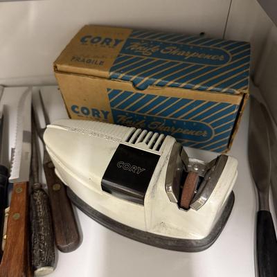Sale Photo Thumbnail #1429: Comes with two shelves of vintage knives and vintage Cory knife sharpener