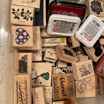 Many wood stamps in clear plastic tote