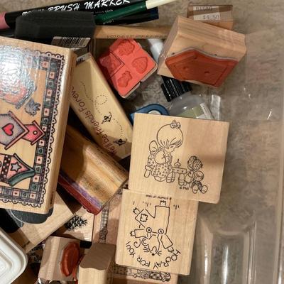 Many wood stamps in clear plastic tote